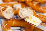 Pretzels being spread with butter