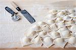 Fresh, homemade ravioli on a floured work surface