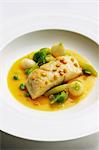 Bass in a saffron sauce with Savoy cabbage, young turnips and yellow split peas