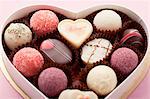 Various pralines in a heart-shaped box