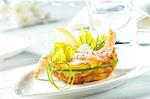 Prawns in a dill and yoghurt sauce with lettuce leaves in a potato nest