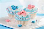 Cupcakes decorated with marzipan flowers and sugar balls