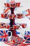 Union Jacks on cupcakes, a cake stand, a teapot and tea cups