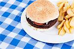 Close-up of hamburger and French fries on table
