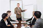 Man using whiteboard in business meeting