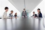Portrait of smiling business people in conference room