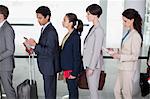 Business people standing in queue at airport