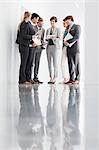 Business people with paperwork meeting in corridor