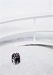 Business people meeting in huddle in courtyard