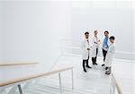 Portrait of smiling doctors on landing of stairs