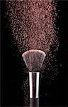 Blush powder blowing from makeup brush