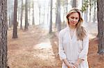 Portrait of serene woman in sunny woods