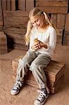 Girl holding chick in barn