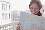 Smiling woman looking down at map