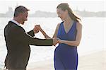 Happy well-dressed couple dancing at waterfront in Venice