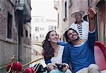 Happy couple in gondola on canal in Venice