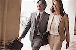 Smiling businessman and businesswoman walking