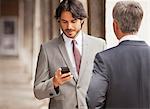 Businessman checking cell phone