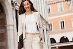 Portrait of smiling businesswoman walking