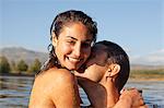 Close up portrait of couple kissing in lake