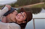 Enthusiastic couple hugging at lakeside