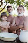 Portrait of multi-generation men with arms crossed and shaving cream on faces