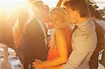 Portrait of smiling woman dancing with man on sunny balcony