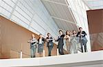 Portrait of smiling business people leaning on balcony railing