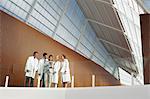 Doctors and businesswoman using digital tablet on modern balcony