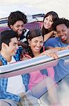 Smiling friends driving in convertible