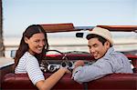 Smiling couple sitting in convertible