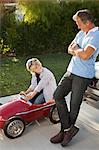 Father and son playing with go cart