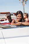 Smiling woman sitting in convertible