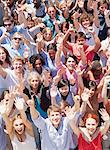 Portrait of crowd cheering with arms raised