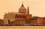 Il Redentore church dating from 1576, on Giudecca island, and Giudecca Canal with vaporetto, at sunset, Venice, UNESCO World Heritage Site, Veneto, Italy, Europe