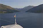 A cruise ship begins its early morning navigation of the winding route to Kotor, Montenegro, Europe