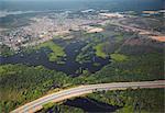 Aerial view of development encroaching on the Amazon rainforest and Rio Negro, Manaus, Amazonas, Brazil, South America
