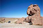 Jeep driving through rocky landscape on the Altiplano, Potosi Department, Bolivia, South America