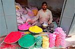 Man selling colored powders for Holi festival, Barsana, Uttar Pradesh, India, Asia