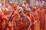 Barsana villagers celebrating Holi in Nandgaon, taunting Nandgaon villagers who throw colored fluids over them, Nandgaon, Uttar Pradesh, India, Asia