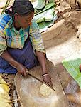 Lady chopping false banana Chencha, Dorze, Ethiopia, Africa