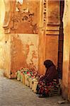 Woman Sitting on Stool with Line of Bags Beside Her in the Old Town, Medina, Marrakesh, Morocco, Africa