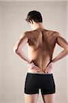 Backview of Young Man wearing Underwear with Hands on Hips with Back Pain, Studio Shot