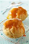 Close-up of Caramel Choux Buns on Rack, Studio Shot