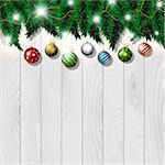 Christmas baubles on a light wooden background