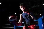 Young adult boxer fighting on the ring