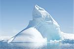 Icebergs in the sunny bright light on the background of the island.