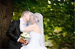 kiss of bride and groom outdoors