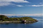 Lone old fishing hut on Lofoten islands in Norway set in picturesque panorama of norwegian coast