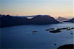 Cloudy mountain peaks lit by midnight sun on Lofoten Islands in Norway